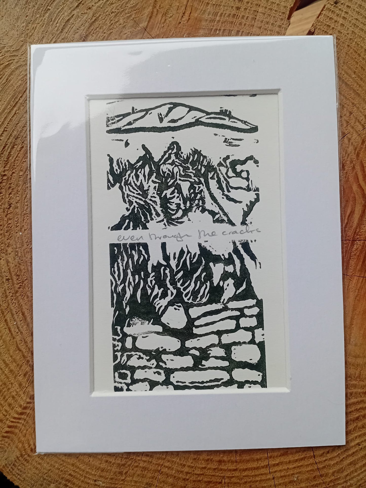 A mounted original lino print called Even Through the Cracks from Analogish. Handmade in Manchester