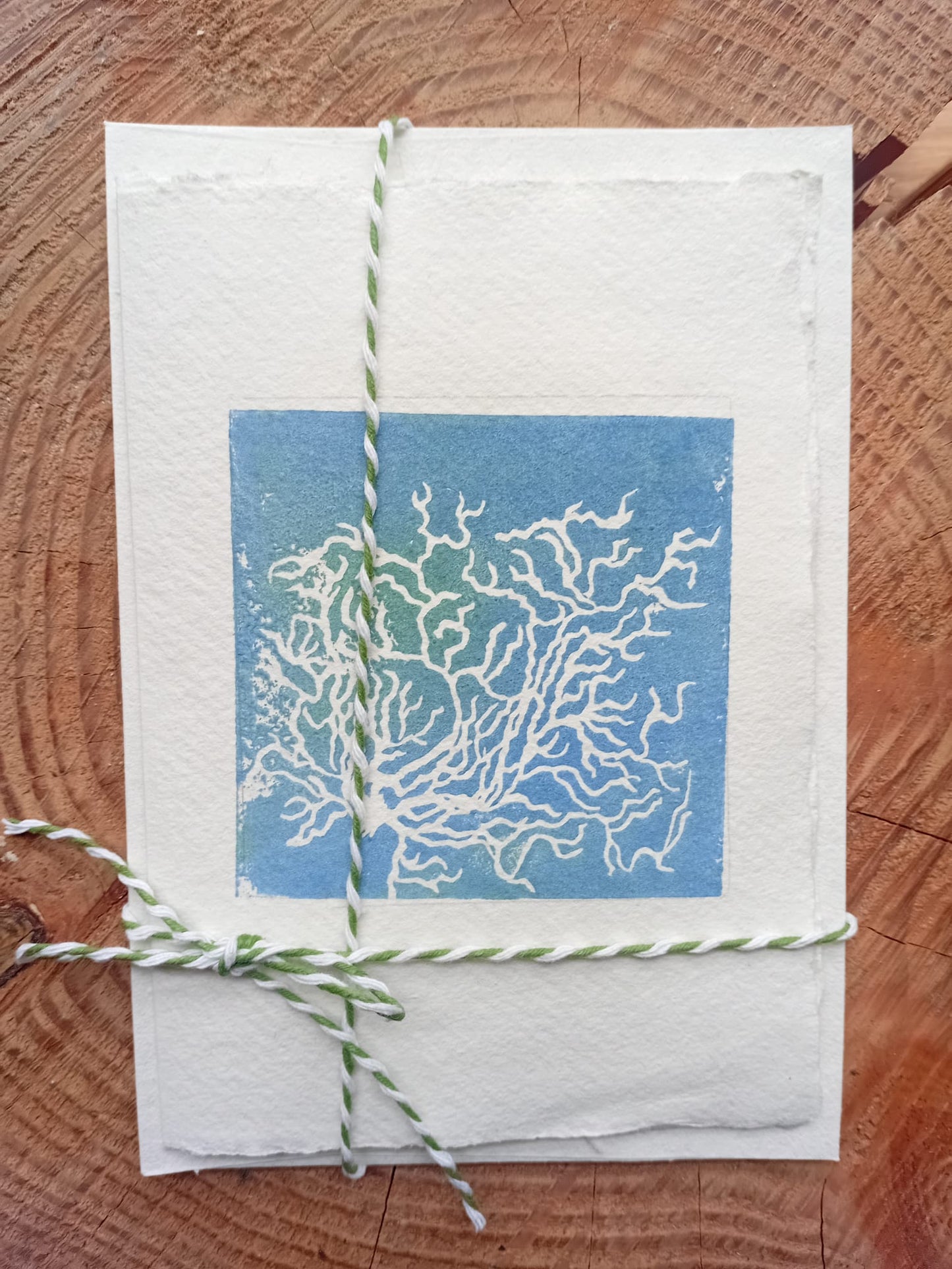 Handmade card depicting ground frost on a wooden background. Made in Manchester