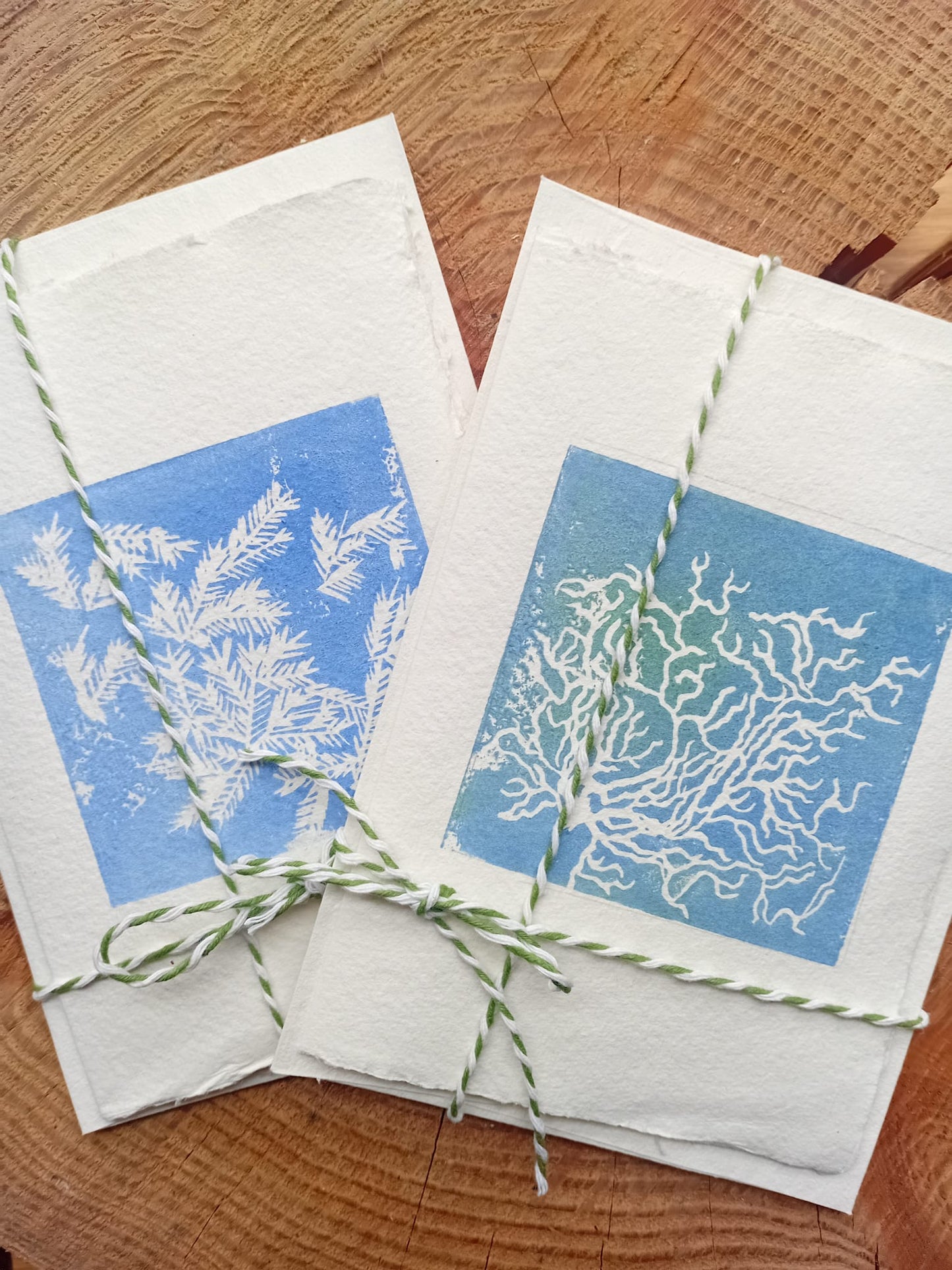 Two handmade cards on a wooden background.