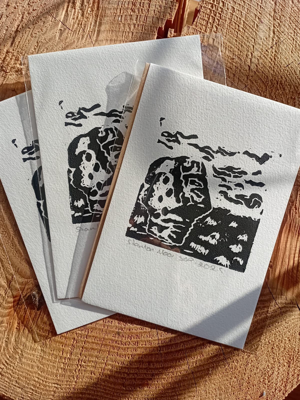 Set of three A6 Stanton Moor Lino Prints depicting the large gritstone boulder on Stanton Moor in Derbyshire.
