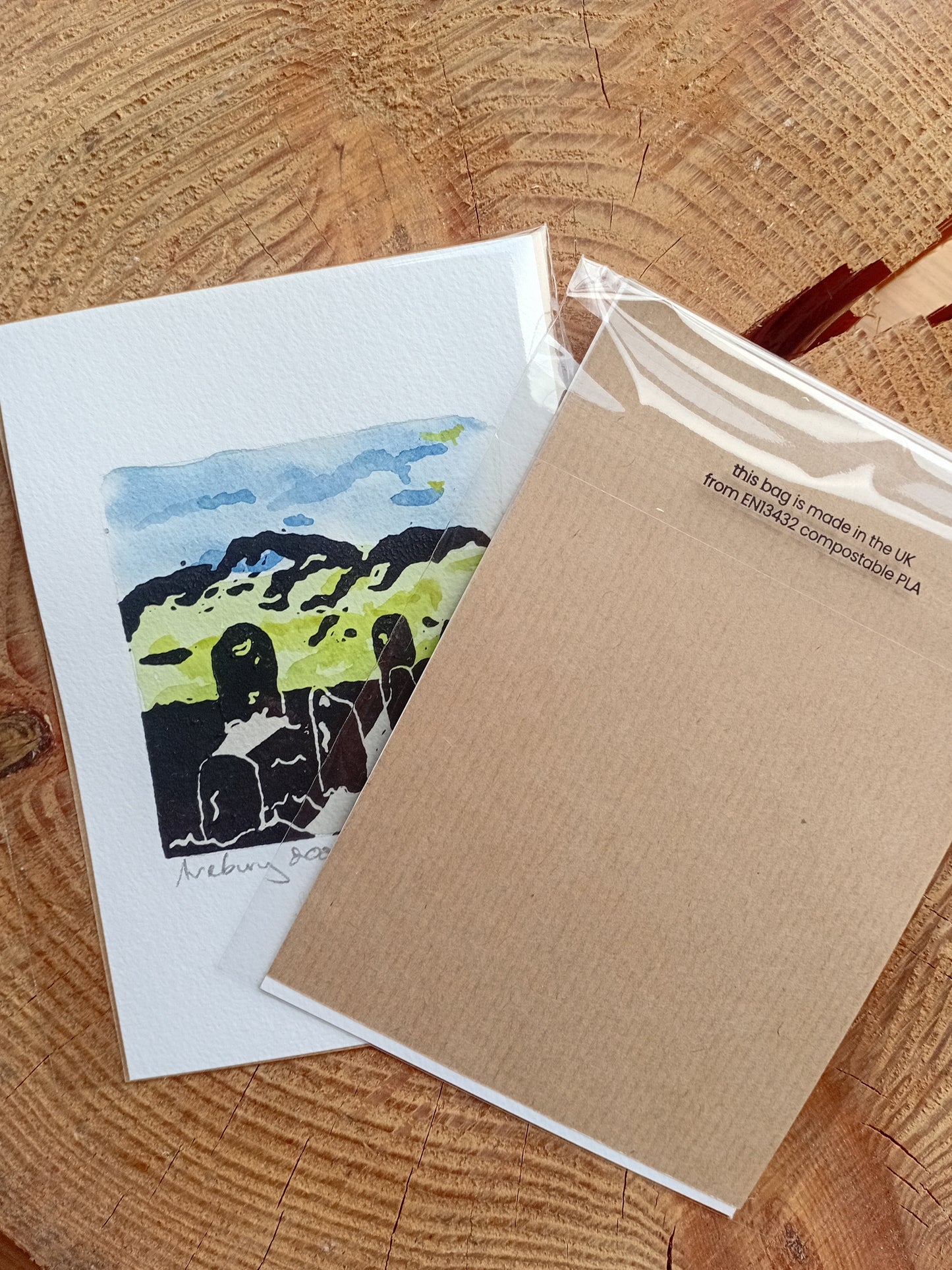 Original lino printed artwork of the Avebury Stones in Wiltshire. Example of back and front showing the plastic cover is compostable.