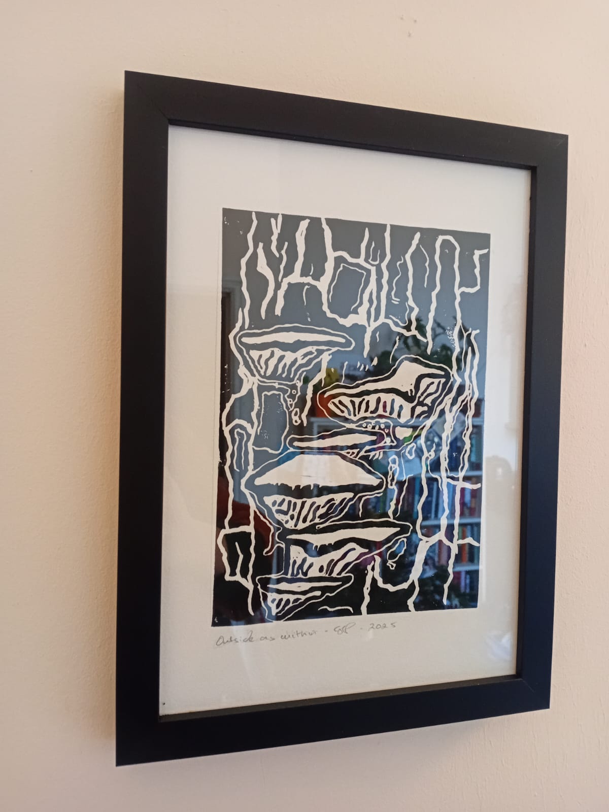 Framed fungal artwork on a beige wall
