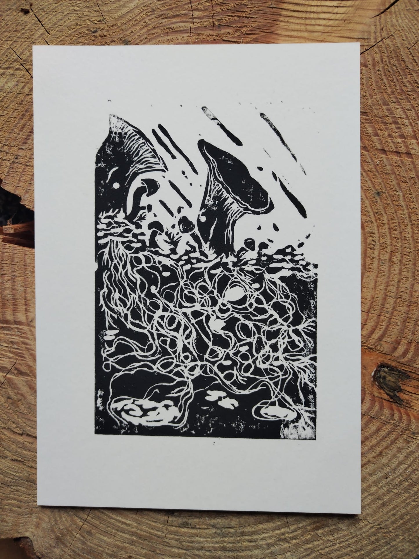 A linocut print of king oyster mushrooms in the rain, handmade by Sophie Cochrane-Powell in her Manchester home studio. 