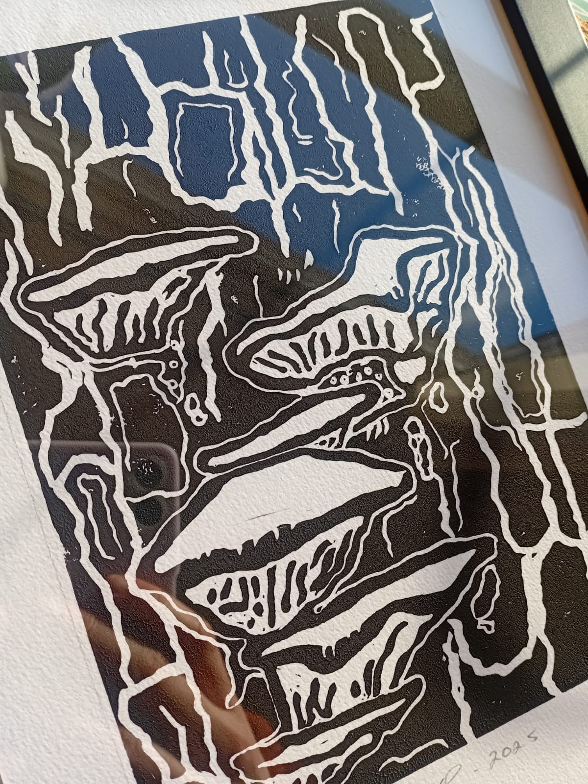 Close-up of black ink lino print "As Outside as Within", made by local artist in Manchester