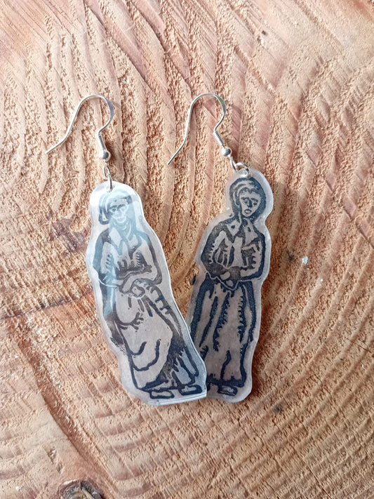 Pair of earrings with a design on a wooden surface. These earrings have been made from an original lino cut. 